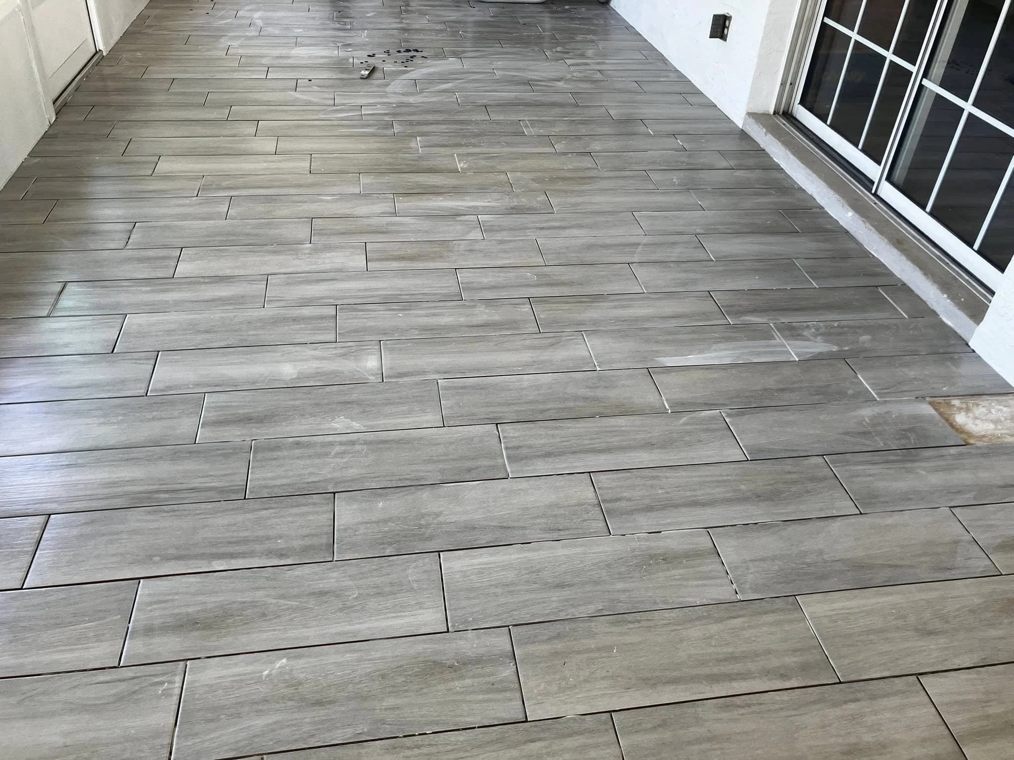 Large-format floor tile installation with perfectly spaced grout lines