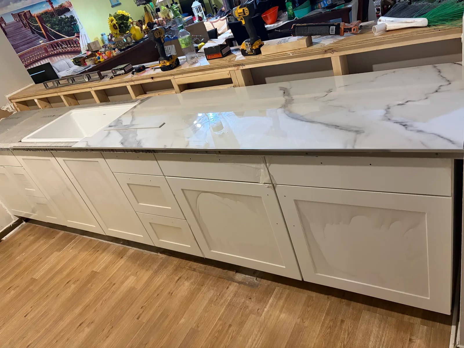 Calacatta marble-look kitchen countertops over white shaker cabinets